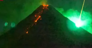 A Fiery Visitor From Space Photo-Bombs an Erupting Volcano