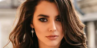 Attractive faces draw our gaze but fail to hijack our peripheral attention